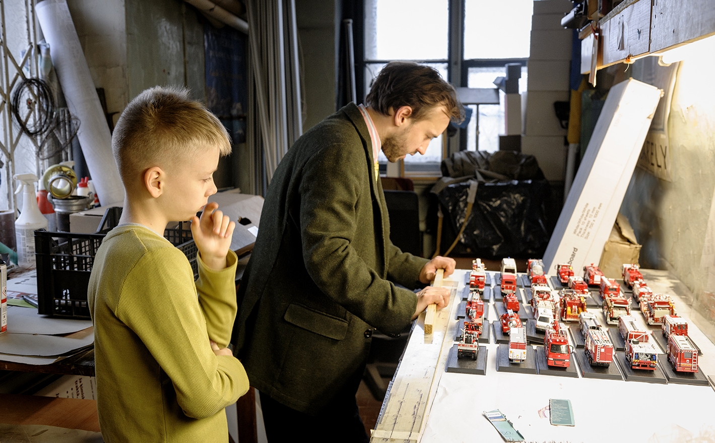 Muzeja vecākais speciālists Rūdolfs Reinis Vītoliņš iepazīstina ēnotāju ar ugunsdzēsības transportlīdzekļu modelīšu kolekcijuu